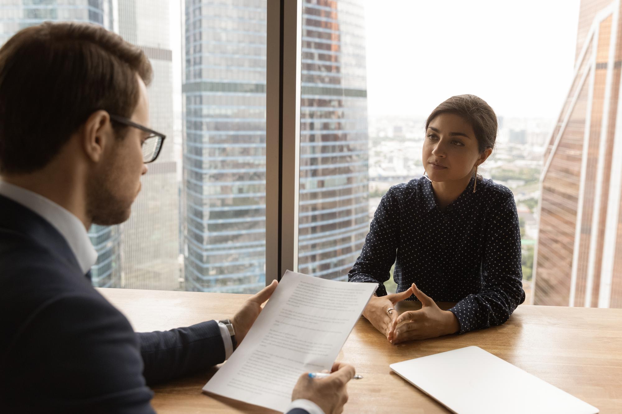 Employment dispute resolution specialist mediating workplace conflict between employer and employee